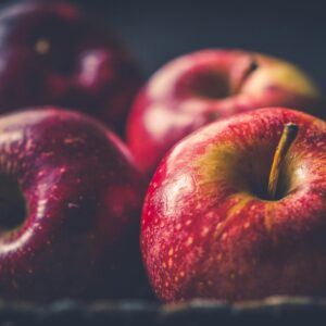 Vibrant red apples glistening with freshness in a close-up view.