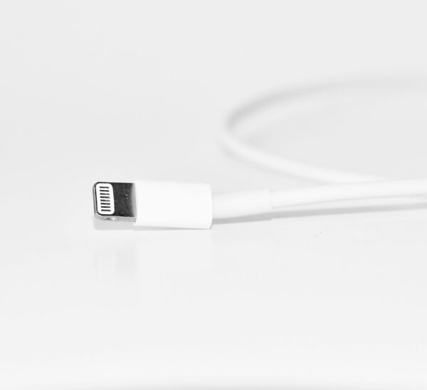 Minimalist close-up of a white charging cable, useful for tech themes.